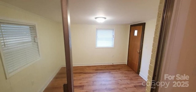 corridor featuring hardwood / wood-style floors and vaulted ceiling