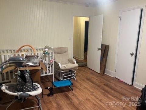 bedroom with hardwood / wood-style flooring and crown molding