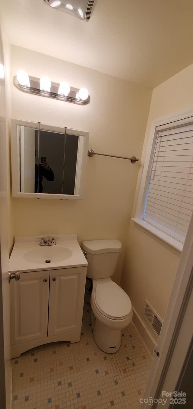 bathroom featuring vanity and toilet