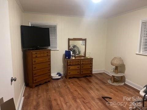 bedroom featuring ornamental molding and dark hardwood / wood-style flooring