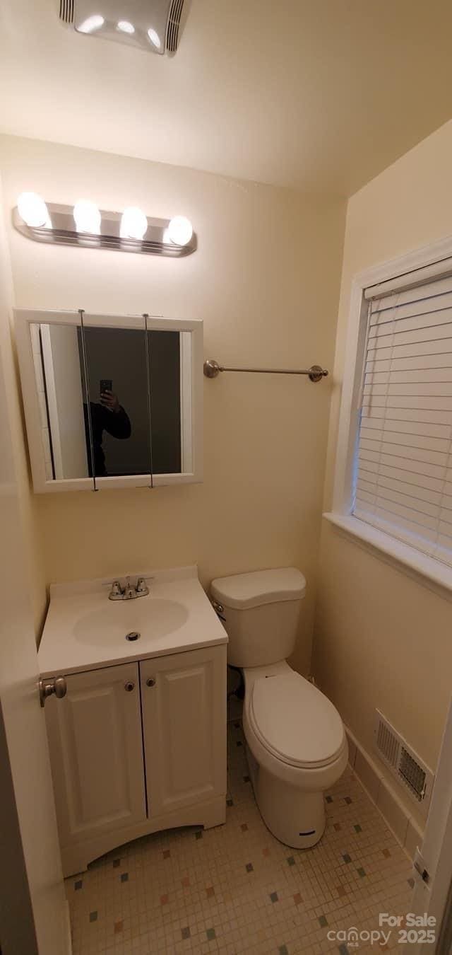 bathroom with tile patterned floors, vanity, and toilet