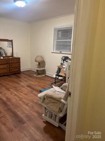 bedroom with hardwood / wood-style flooring and ornamental molding