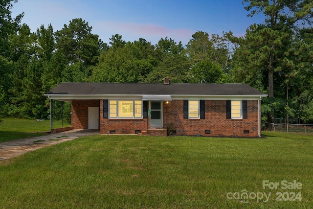 single story home with a lawn and a carport