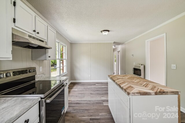 kitchen with stainless steel electric range oven, wood-type flooring, ornamental molding, and white cabinets