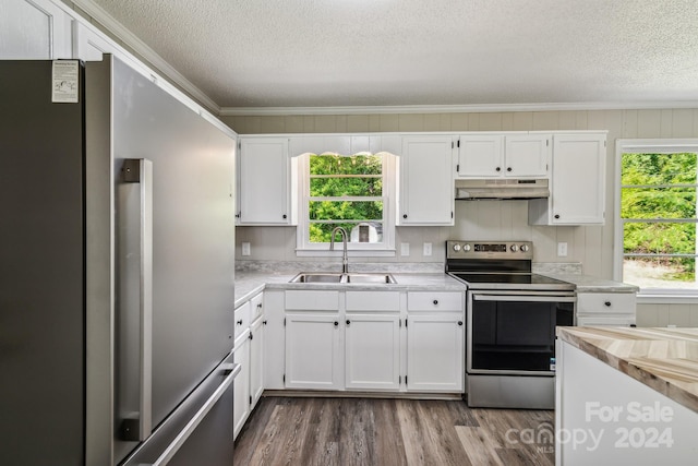 kitchen featuring appliances with stainless steel finishes, sink, hardwood / wood-style floors, and white cabinets