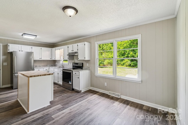 kitchen featuring stainless steel appliances, white cabinetry, a kitchen island, and dark hardwood / wood-style flooring