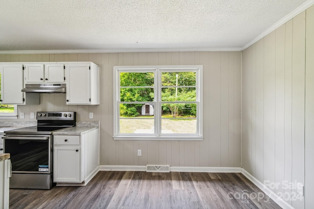 kitchen featuring dark wood-type flooring, white cabinets, a textured ceiling, and stainless steel range with electric stovetop