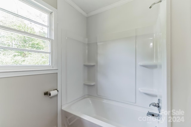 bathroom with shower / tub combination and ornamental molding