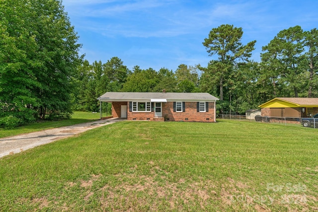 ranch-style home with a front yard and a carport