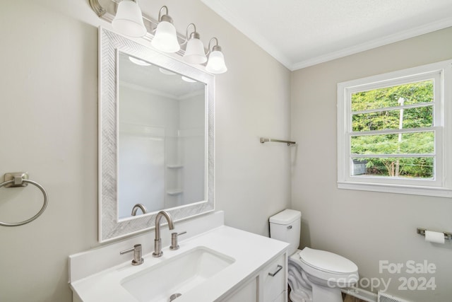 bathroom featuring vanity, ornamental molding, and toilet