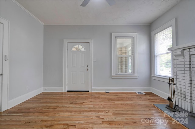 foyer with light hardwood / wood-style floors and ceiling fan