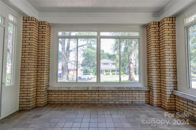 unfurnished sunroom with plenty of natural light