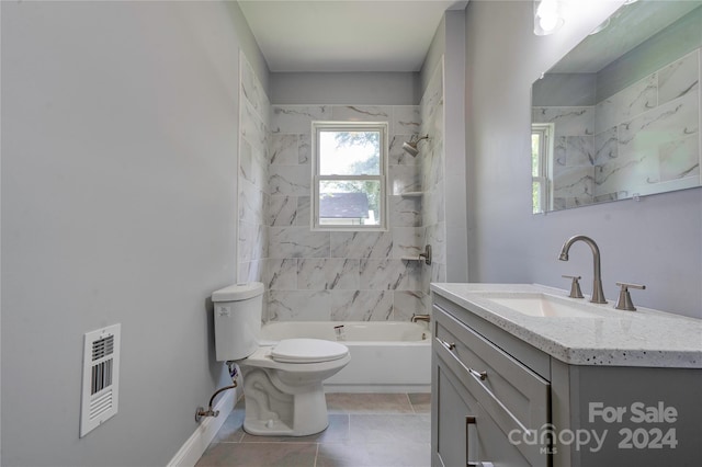 full bathroom with toilet, tiled shower / bath combo, vanity, and tile patterned floors