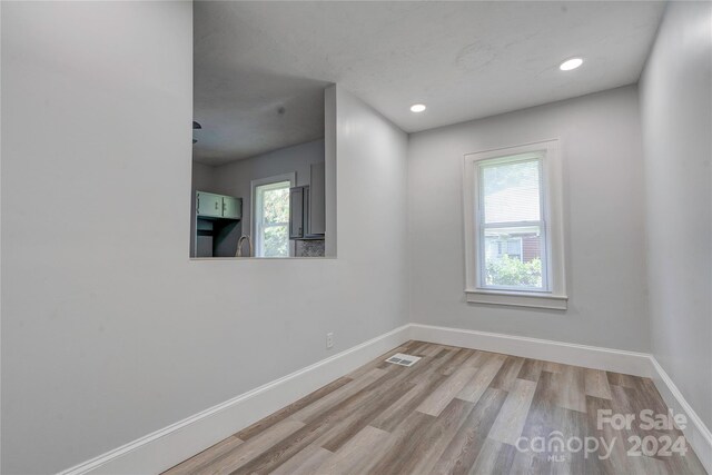 unfurnished room with light wood-type flooring