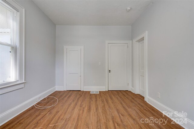 unfurnished bedroom featuring light wood-type flooring