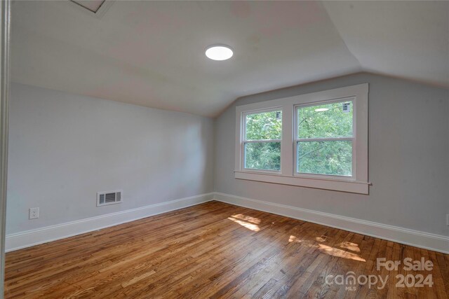 bonus room with wood-type flooring and lofted ceiling