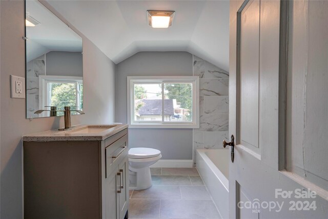 bathroom featuring vaulted ceiling, toilet, tile patterned flooring, and vanity