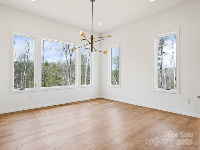 140 Upperfell Ct Unit 708, Asheville, NC 28803 - unfurnished dining area featuring baseboards, wood finished floors, recessed lighting, and an inviting chandelier