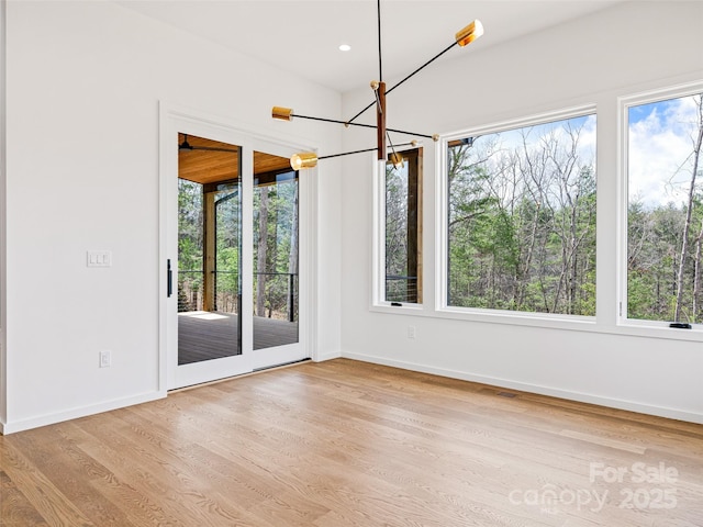 140 Upperfell Ct Unit 708, Asheville, NC 28803 - unfurnished dining area with wood finished floors, baseboards, visible vents, recessed lighting, and an inviting chandelier