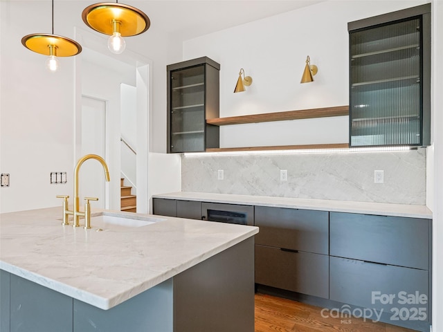 140 Upperfell Ct Unit 708, Asheville, NC 28803 - kitchen with light stone counters, backsplash, a sink, open shelves, and gray cabinetry