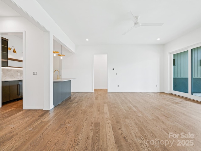 140 Upperfell Ct Unit 708, Asheville, NC 28803 - unfurnished living room with baseboards, light wood-style floors, and ceiling fan