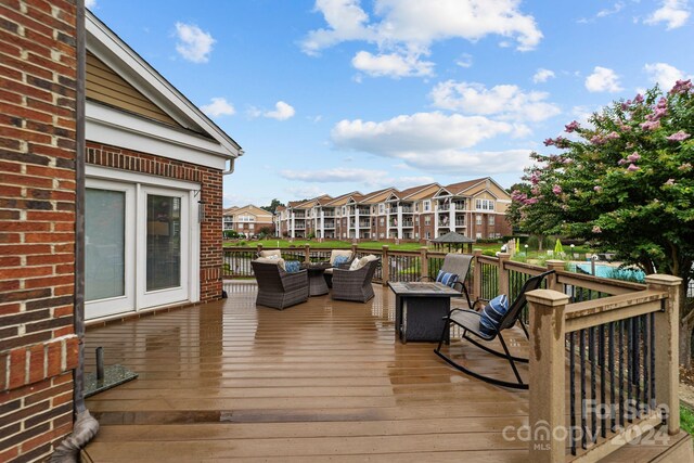 wooden terrace with an outdoor fire pit