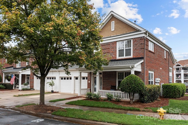 view of front of home featuring covered porch and a garage