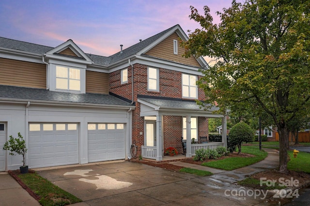 view of front of property with covered porch and a garage