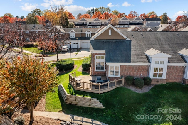 back of house featuring a lawn and a wooden deck