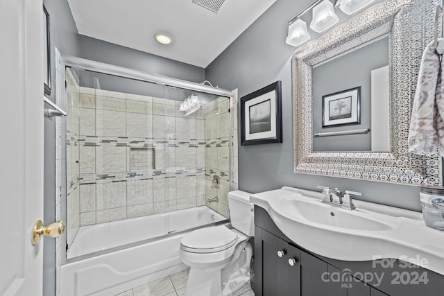 full bathroom with tile patterned flooring, vanity, toilet, and bath / shower combo with glass door