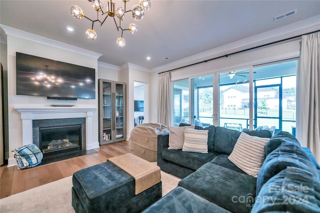 living room featuring light wood-type flooring and ornamental molding