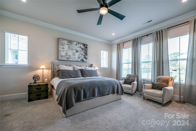 bedroom with carpet floors, multiple windows, and ceiling fan