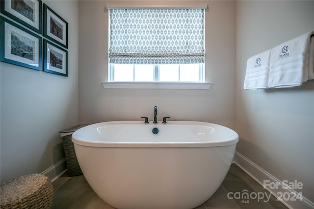 bathroom featuring tile patterned flooring and a bathtub