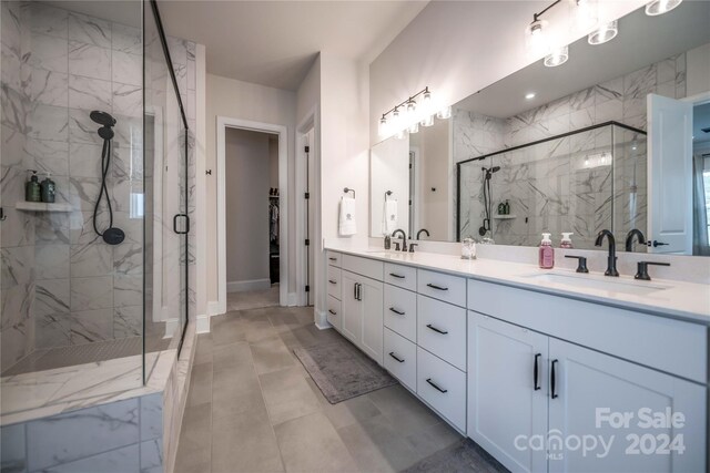 bathroom with a shower with shower door and vanity