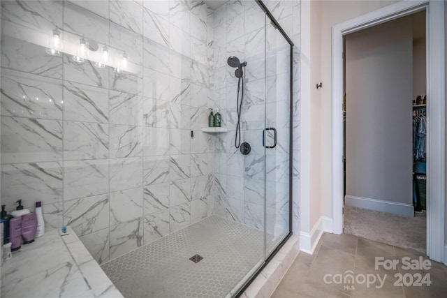 bathroom featuring an enclosed shower and tile patterned floors