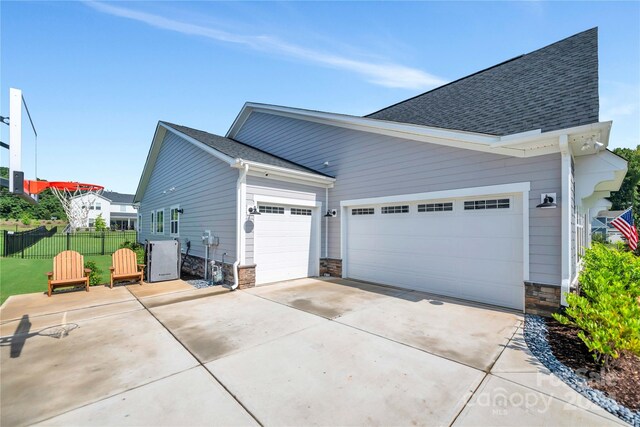 exterior space featuring a garage and a yard