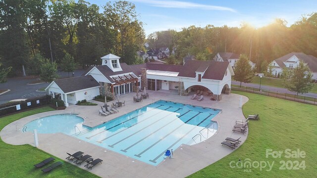 view of swimming pool with a yard and a patio area