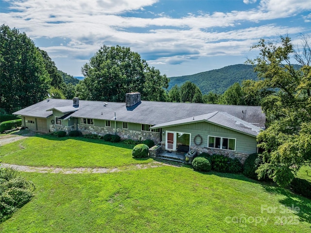 ranch-style house featuring a front lawn and a mountain view