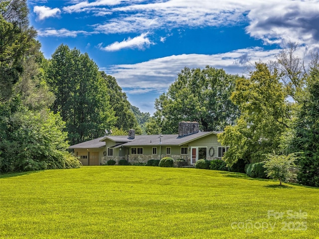 rear view of property with a lawn