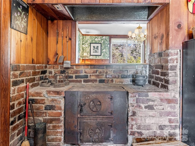 interior details featuring a chandelier and wooden walls