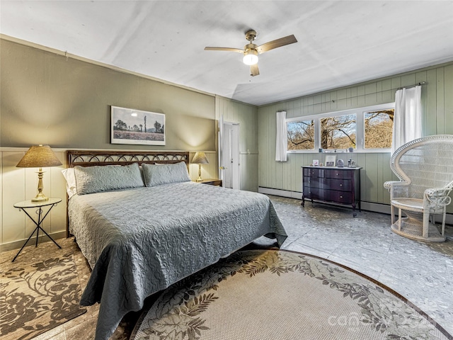 bedroom featuring a baseboard heating unit and ceiling fan