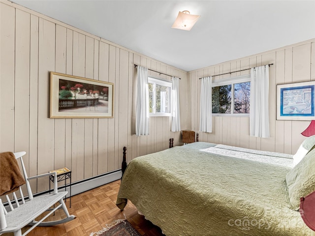 bedroom featuring parquet floors and wood walls