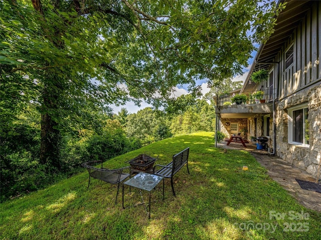 view of yard featuring a patio area and a fire pit