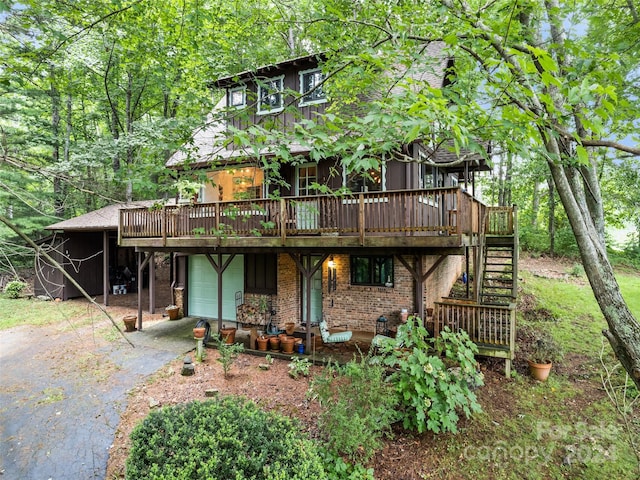 rear view of property featuring a deck