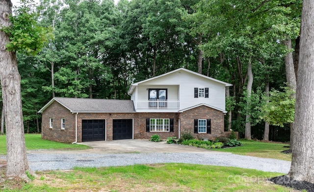 view of front of property with a front lawn, a balcony, and a garage