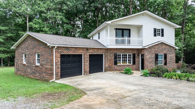 view of property featuring a balcony, a garage, and a front lawn