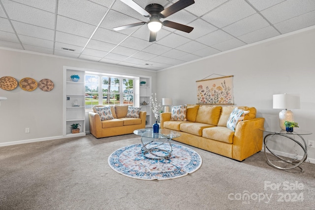 living room with light carpet, crown molding, and ceiling fan