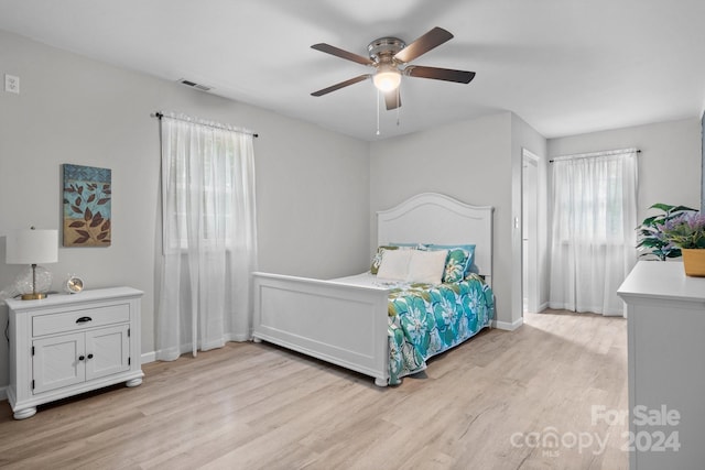 bedroom with ceiling fan and light hardwood / wood-style floors