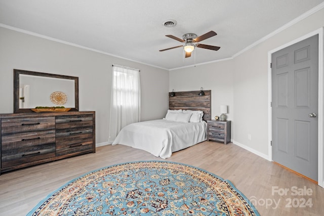 bedroom with ceiling fan, ornamental molding, and light hardwood / wood-style floors