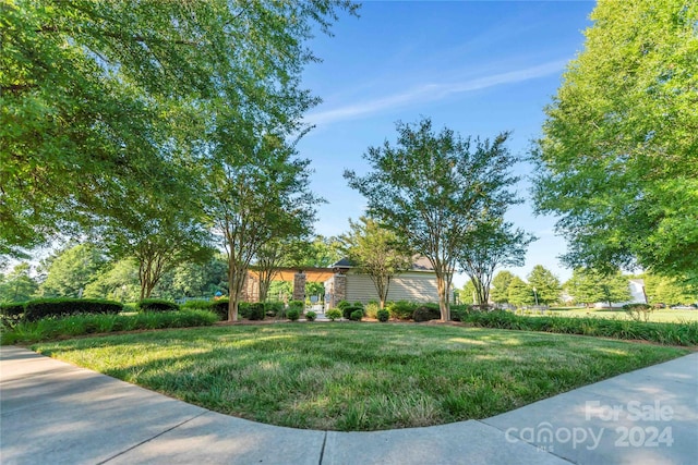 view of side of property with a lawn